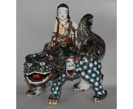 A Chinese ceramic temple dog with figure