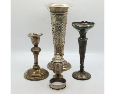 Two hallmarked silver trumpet vases, napkin ring and pepperette, combined 191g, with a hallmarked silver candlestick (5), den