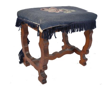 An 18th century Queen Anne walnut stool. The carved walnut legs of inverted arch form united by crinoline stretcher. Above an