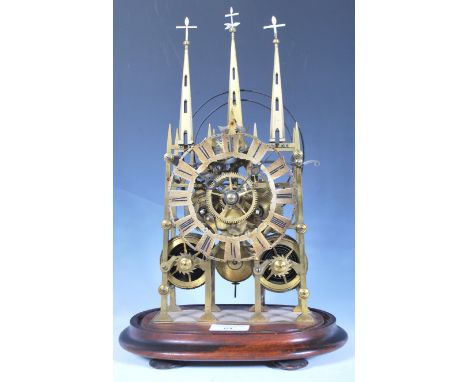 A 19th Century English brass Gothic skeleton clock in the form of an ecclesiastical church. Double fusee movement with Roman 