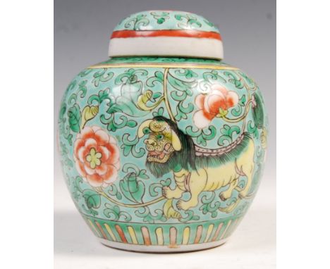 A 19th Century Chinese Famille Verte decorated porcelain ginger jar and cover depicting Fu Dogs with floral medallions and sc