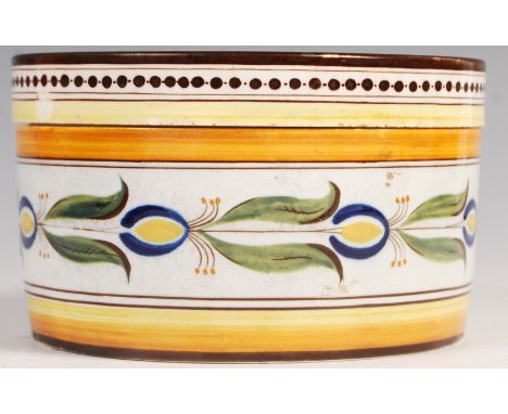 An early 19th century believed French ceramic lidded storage pot having floral decoration with Mediterranean colours, the lid