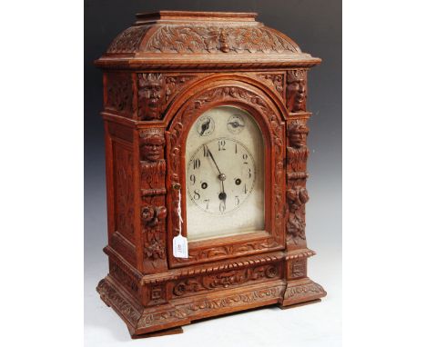 An early 20th Century German carved oak Blackforest Black Forest mantel bracket clock having a Junghans B07 movement having f