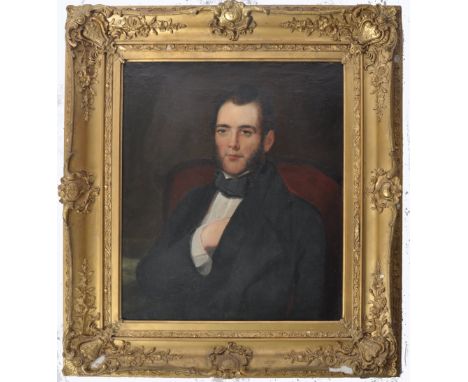 An early 19th Century Georgian oil on canvas portrait painting depicting an aristocratic gentleman wearing black overcoat wit