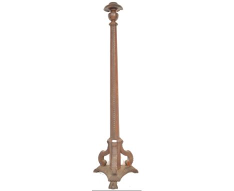 An early 20th Century Arts and Crafts leather and mahogany standard lamp raised on a scrolled base with studded leather work 