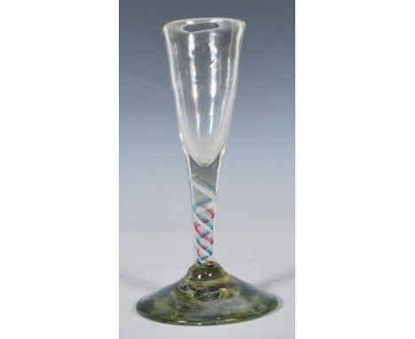 A mid 18th Century Georgian wine drinking glass having a trumpet shaped bowl with coloured helix twist stem over deep circula