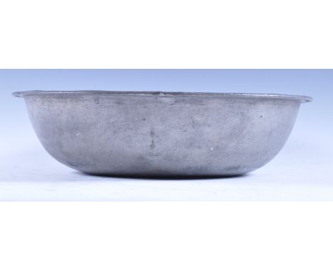 An 18th Century rare pewter bowl basin of simple plain form having a lined rim with remains / traces of touch marks to verso.