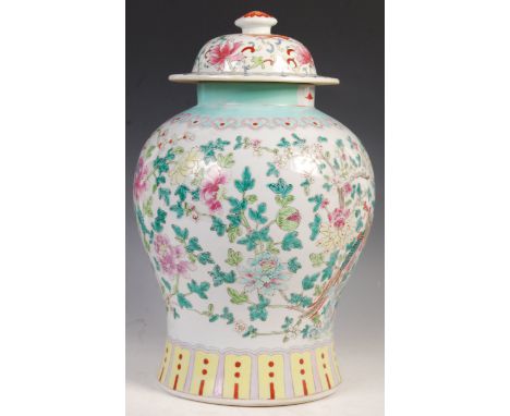 A large and impressive late 19th Century Chinese temple jar and cover having a white enamel ground decorated with birds of pa