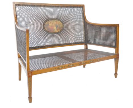 A late Victorian&nbsp; / Edwardian satinwood hand painted bergere drawing room caned two seat sofa. Raised on squared legs wi
