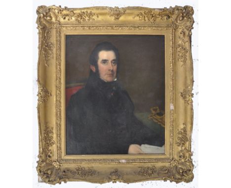 An early 19th Century Victorian oil on canvas portrait painting depicting an aristocratic gentleman wearing black overcoat wi