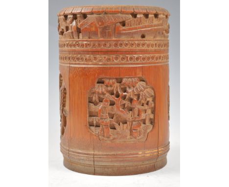 A late 19th Century Chinese Qing Dynasty carved bamboo tea caddy and cover having carved cartouche panels depicting figures a