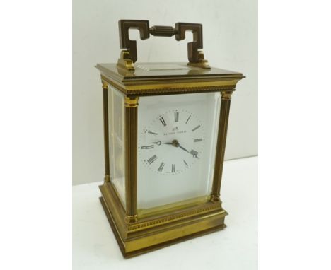 A "MATTHEW NORMAN" BRASS CASED CARRIAGE CLOCK having architectural column form with bevel cut glass panels, 8-day chiming mov