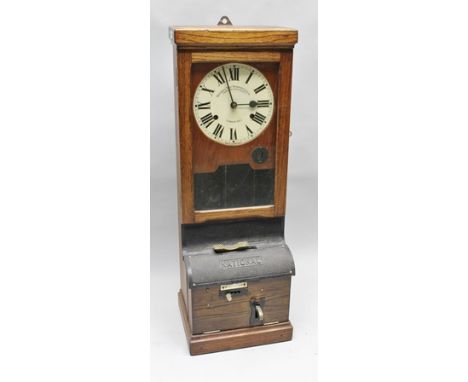 "NATIONAL TIME RECORDER CO. LTD. OF LONDON" AN OAK CASED CLOCKING-IN CLOCK, with mechanical movement, the dial with Roman num