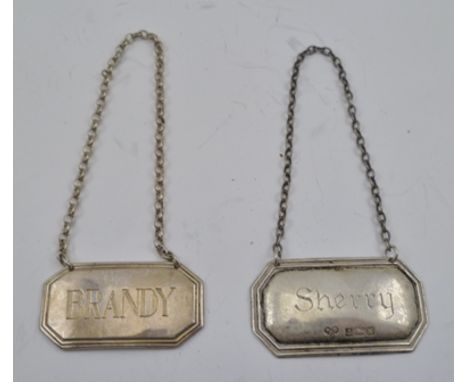 TWO GEORGIAN DESIGN SILVER SPIRIT LABELS, "Brandy" and "Sherry", having canted corners with pressed frames, on chain suspensi