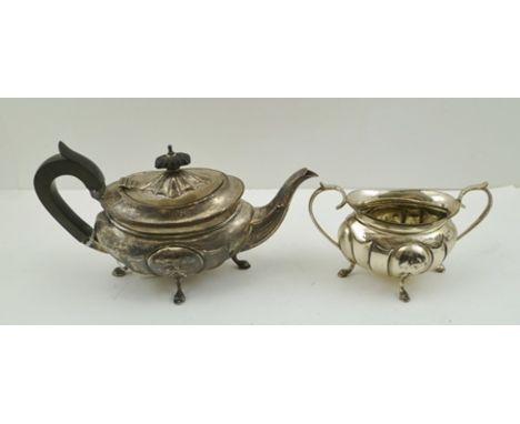 AN EARLY 20TH CENTURY SILVER BACHELOR TEAPOT, having lobed body, raised on four feet, together with the two-handled SUGAR BOW