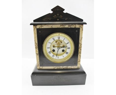 A LATE VICTORIAN BLACK SLATE CASED MANTEL CLOCK of architectural design, the white enamel dial with Roman numerals and visibl