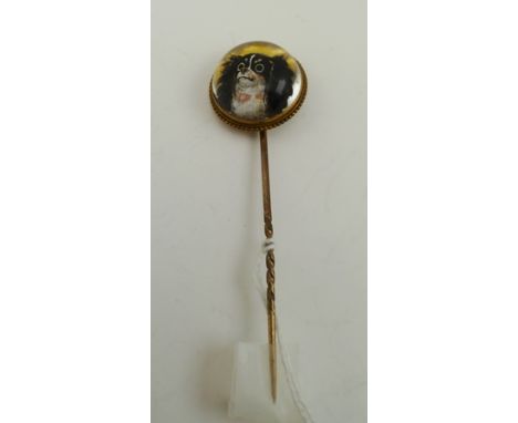 AN ESSEX CRYSTAL STICK PIN, mounted with a reverse intaglio, painted image of a King Charles Spaniel, 7.5cm long 