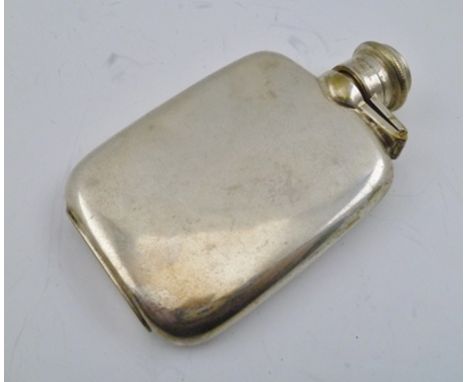 A SILVER PLATED SPIRIT FLASK, having hinged twist cap, in chamois leather outer case, 10cm high 