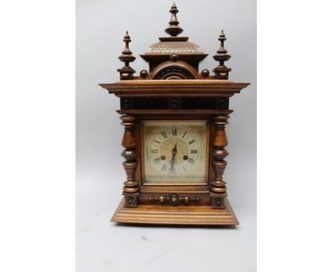 A LATE VICTORIAN MANTEL CLOCK, having stained wood architectural case, the dial with Roman numerals, fitted 8-day chiming mov