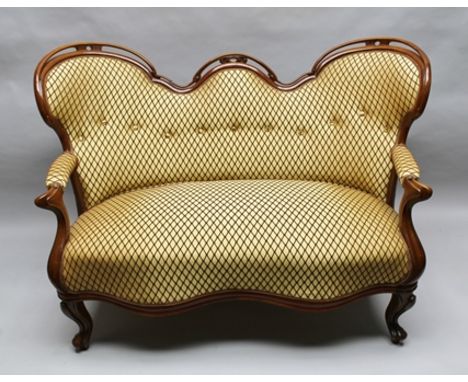 A VICTORIAN CARVED SHOW WOOD FRAMED TWO-SEATER SETTEE, having pierced and carved scroll back with open arms, gold coloured fa