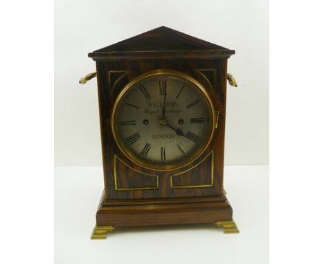 A REGENCY DESIGN BRACKET CLOCK, having Coromandel case with architectural pediment, brass mounted with side handles and fish 