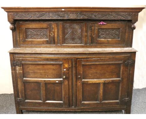 Oak court cupboard with two small over two larger panelled doors and dated 1613 to the carved cornice on straight supports, 1