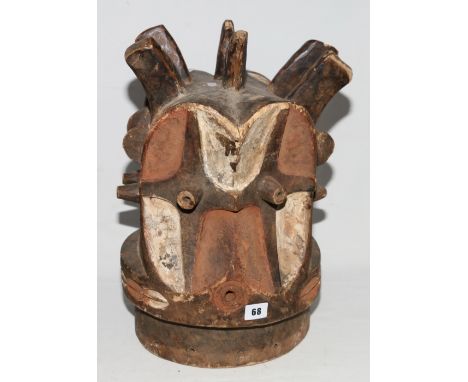 Democratic Republic of Congo, Bembe, carved wood Janus helmet, the concave faces with cross decoration to the projecting eyes