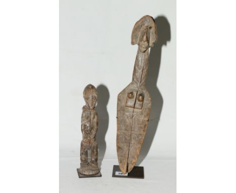 African sculpture of a female, the body and head of arrow shape, incised decoration, metal stand, 40cm, and a standing figure