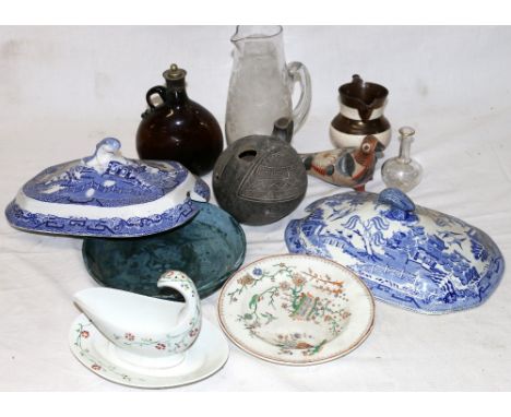 Two 19th century English blue and white tureen lids, a 19th century brown glass decanter, an etched bottle and an etched jug,
