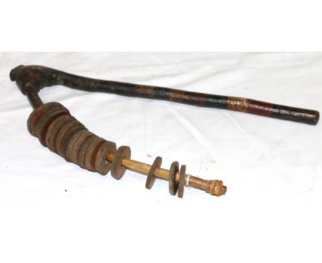 Wooden shaking stick, the handle painted red, black and white, circular wooden discs, 40cm