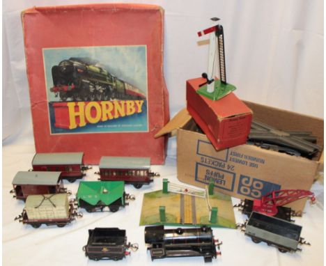 A selection of 0 gauge railway items including clockwork BR tank engine and tender, various goods wagons, boxed single arm si