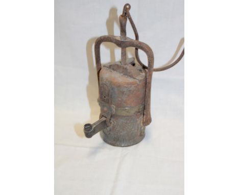 A brass mounted steel miner's acetylene open flame miner's lamp