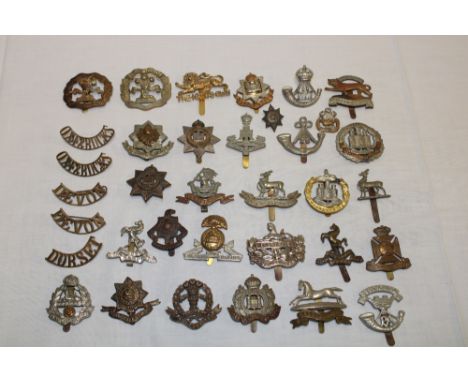 A selection of approximately 30 various military cap badges including the Worcester Regiment, West Yorkshire, Somerset Light 