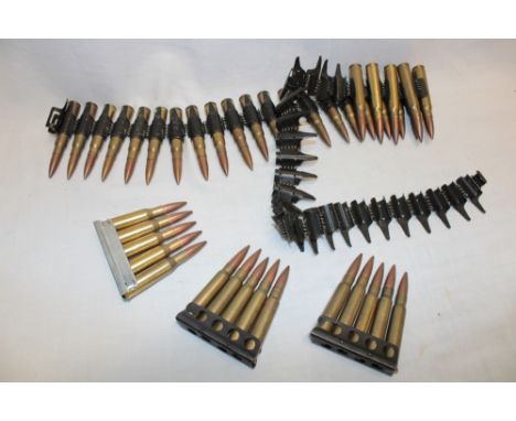 A part machine gun belt of German MG42 inert rounds, 2 inert clips of Lee Enfield 303 ammunition and one inert clip of Mosin 