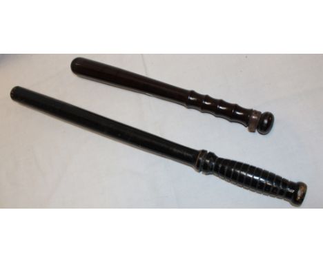 A turned wood police truncheon and a painted wood police baton (2)