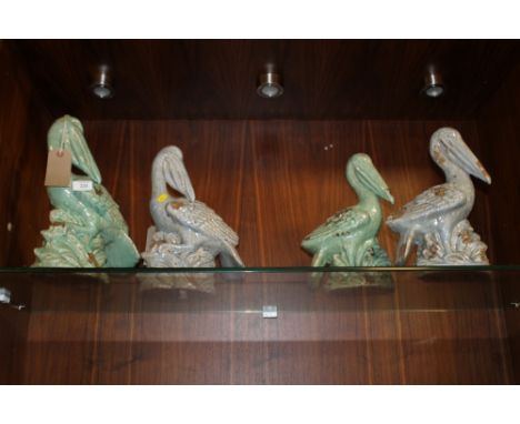 TWO PAIRS OF CERAMIC PELICAN FIGURES