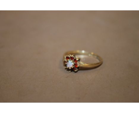 A 9 CARAT GOLD OPAL AND GARNET DRESS RING