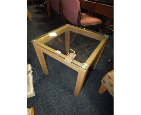 A SMALL GLASS TOPPED LAMP TABLE