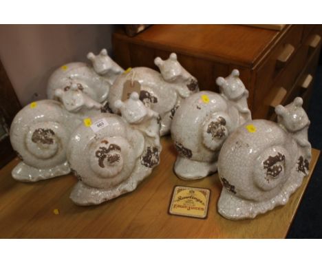 A SET OF SIX CERAMIC SNAILS