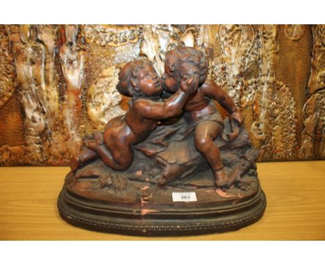 A CERAMIC SCULPTURE OF A YOUNG BOY AND GIRL KISSING A/F 