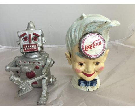 Two cast-iron money boxes: one in the form of a robot, the other Coca Cola