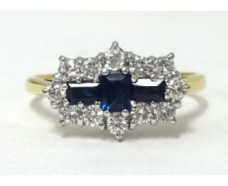 An 18ct gold, diamond and sapphire ring, set with 3 baguette cut sapphires and a cluster of 12 diamonds, finger size R.