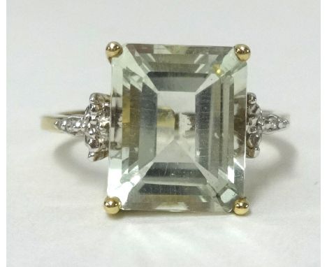 A 9ct gold large light green amethyst and diamond ring, finger size N.