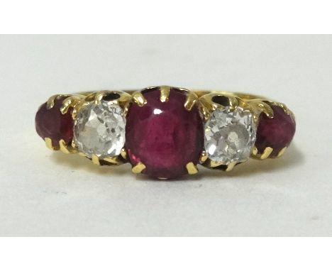 An antique yellow gold ruby and diamond set five stone ring, (no hallmark) finger size Q 1/2.