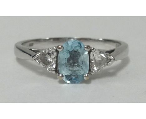 An 18ct white gold, heart shape diamond and aquamarine ring, finger size R.