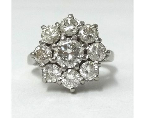 An 18ct white gold diamond cluster ring, having a round brilliant cut centre stone approx 0.70ct, surrounded by eight round b
