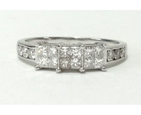 A platinum ring set with 18 princess cut diamonds, finger size R.