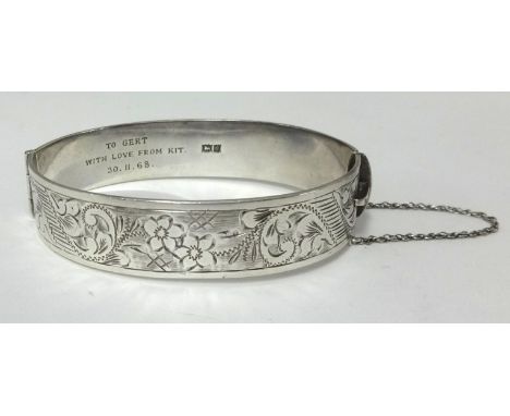 A silver bangle.