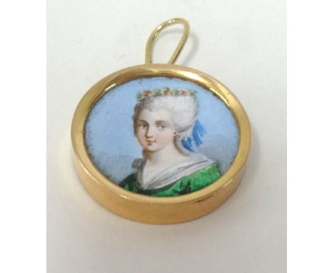 A miniature painted portrait of a lady set in gold.