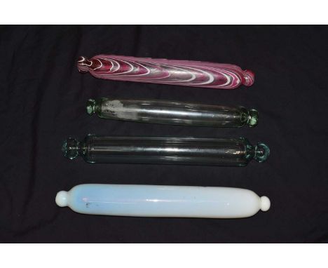 Four Victorian Nailsea glass rolling pins, one with typical festoon decoration, 44cm long and smaller (4)